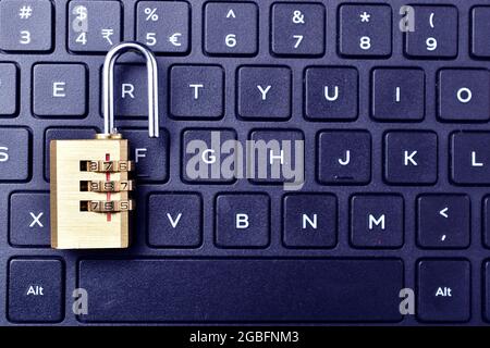 computer security. Unlocked padlock on a laptop`s keyboard. Stock Photo